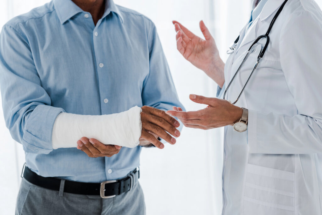 Doctor examining a patient's broken arm after a personal injury